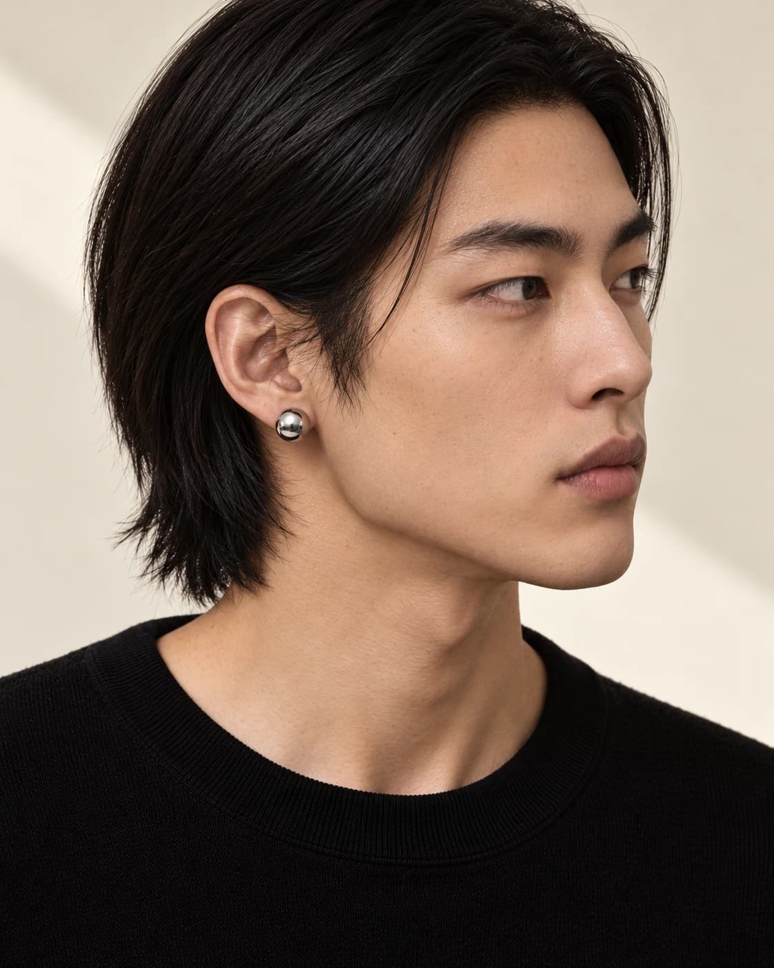 Pair earrings, polished sphere worn by the male model in profile