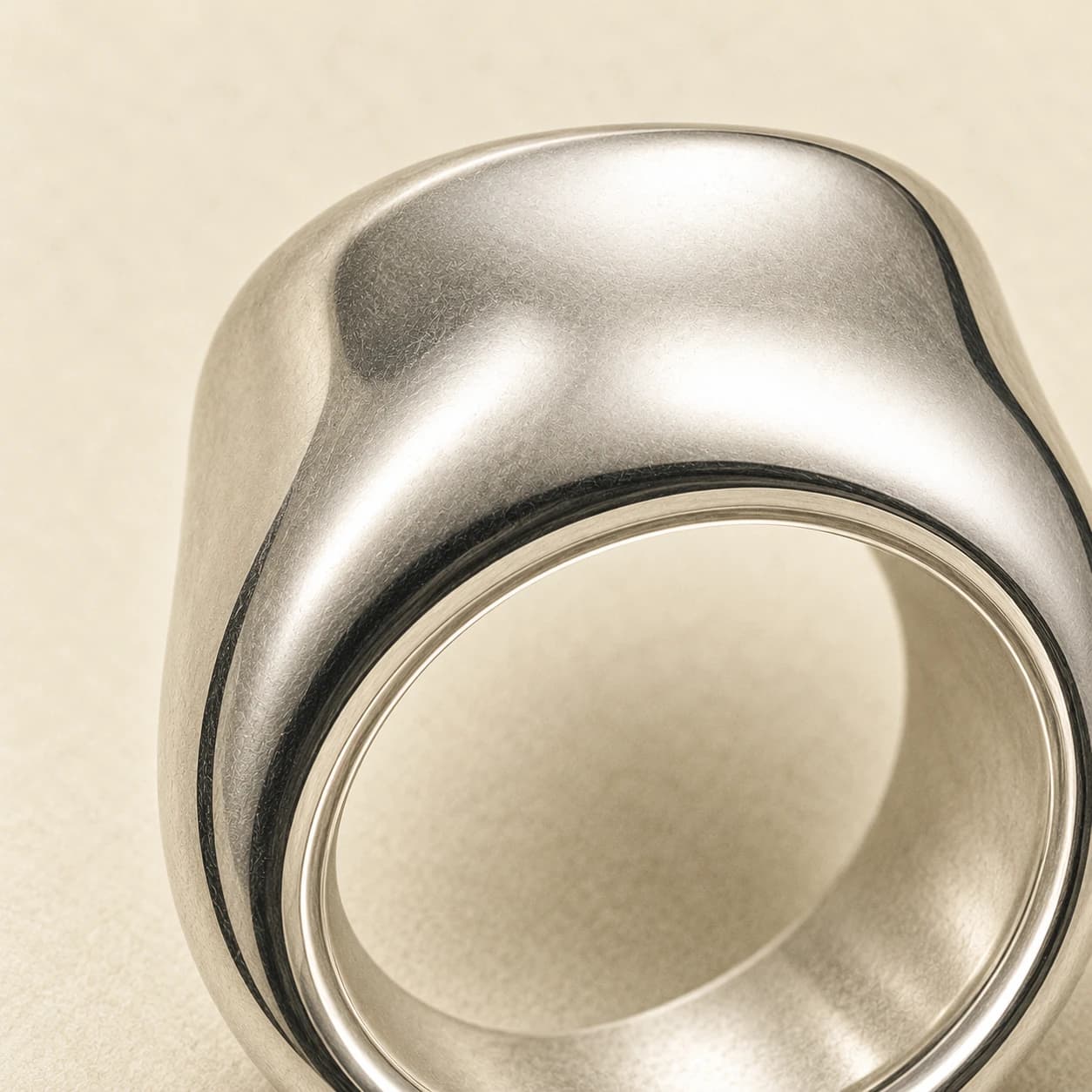 Pocket ring, polished metal with a sculpted hollow