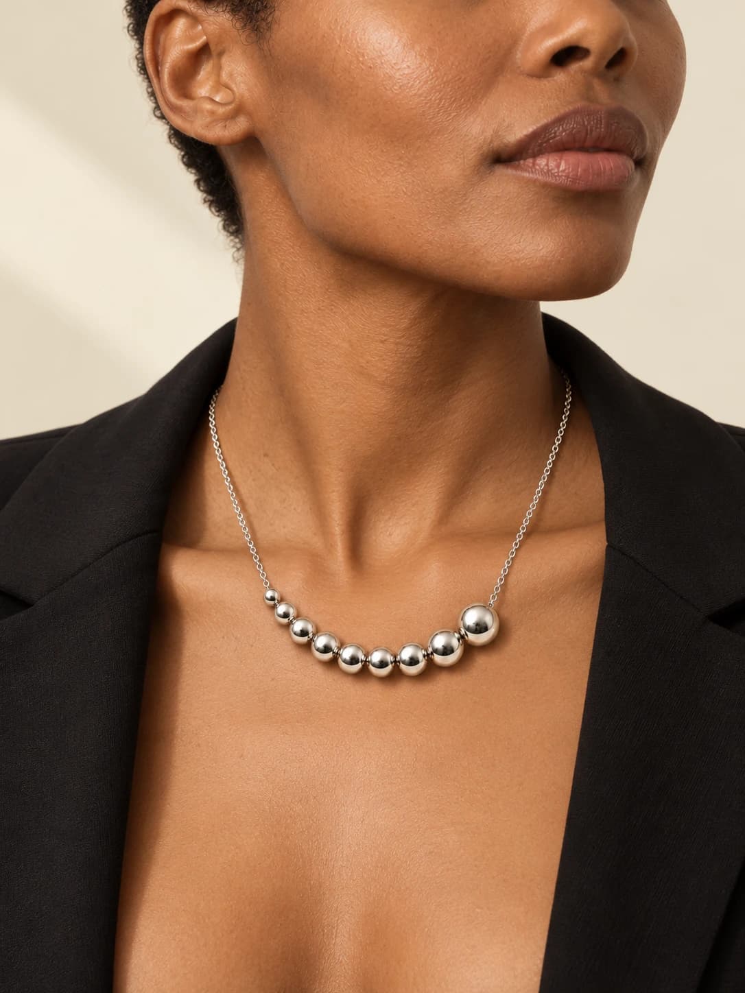 Rack strand, worn by a woman in a black tailored jacket